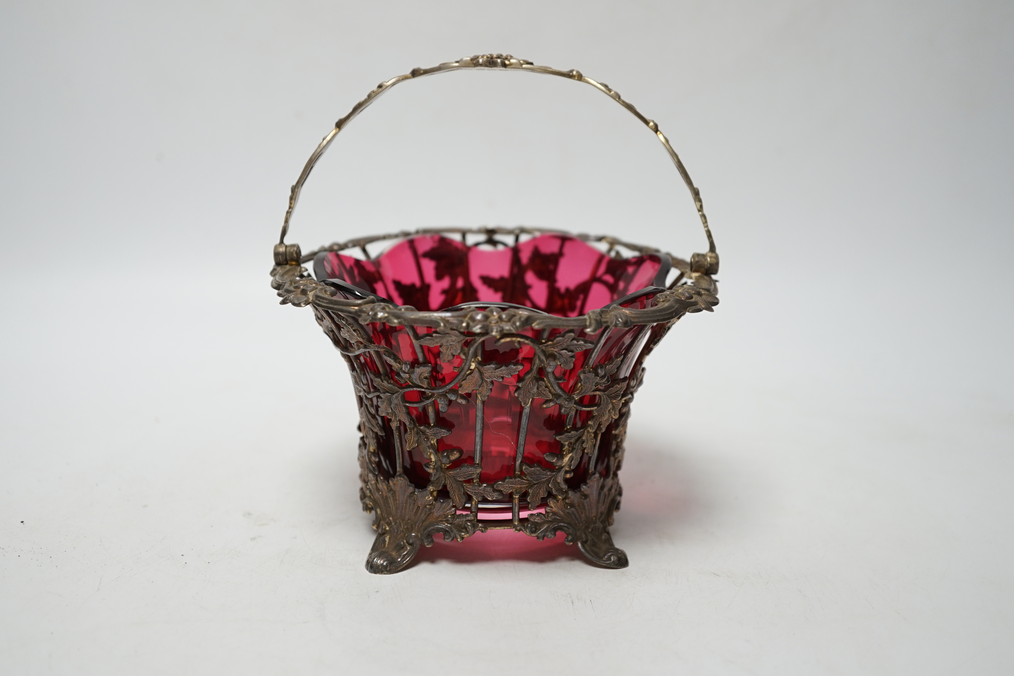 A Victorian pierced silver sugar basket, Hawksworth, Eyre & Co, Sheffield, 1842, with cranberry glass liner, diameter 13.7cm.